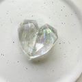 Close-up of heart-shaped laser crystal phone socket stand with multifaceted iridescent finish - Geometric Heart (Large) / Aurora