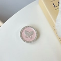 Macro detail of foldable phone grip with pink textured base and crystal butterfly - Pink