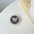 Detail of silver phone grip with butterfly crystal inlay and black glitter finish - Gray
