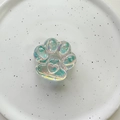 Detail of laser iridescent cat paw phone grip with heart relief on white ceramic tray - Cat Claw (Glossy) / Blue