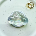Close-up of holographic cloud phone grip holder with iridescent finish on a ceramic plate - Magnetic Cloud - Aurora