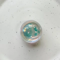 Macro shot of iridescent crystal ball phone grip showing colorful pearlescent finish - Crystal Ball / Blue