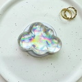 Close-up of cloud-shaped iridescent pop socket with laser rainbow effect on a white base - Magnetic Cloud - Silver Laser