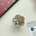 Detailed view of flower-shaped mirror phone grip with crystal inlay and golden bow decoration - Camellia / Gold