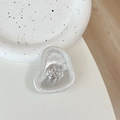 Detailed view of silver camellia flower ornament on a clear irregular drop hair claw clip - Tinfoil Texture #16