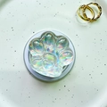 Macro detail of holographic cat paw phone socket with crystal heart texture on white plate - Magnetic Cat Paw - Silver Laser