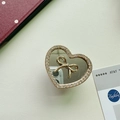 Detailed view of heart-shaped phone grip with gold bow mirror and crystal rhinestones - Small Heart Pendant / Gold