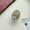 Detail of oval mirror phone grip featuring a gold bow and shimmering rhinestone border - Small Oval / Gold