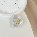 Detail view of heart-shaped phone grip with metallic gold core and pearlescent base - Tinfoil Texture #20