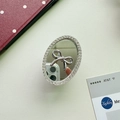 Detail view of oval mirror phone grip with silver bow and sparkling rhinestones on leather - Small Oval / Silver