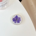 Macro detail of round phone socket featuring real purple flower and golden edge - Transparent Stand - Gold Ring Glitter Swallow - Dark Purple
