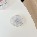 Detailed macro of a clear resin phone socket with real purple dried flower and gold rim - Transparent Stand - Gold Ring Glitter Swallow - Purple Blue