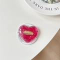 Macro shot of pink glitter heart phone grip with gold metallic engraved nameplate - Rose Red