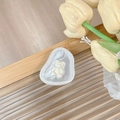 Detail of magnetic phone grip featuring a 3D resin bear on frosted pebble texture - Transparent Socket (Beige)