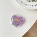 Detail of purple heart resin phone grip with silver glitter and gold lip emblem - Purple