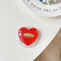 Dettaglio supporto telefono a cuore rosso con glitter e stemma labbra dorate - Rosso