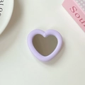 Detail of a lavender heart-shaped phone grip with a built-in mirror on a white table - Light Purple