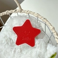 Detail of red leather star phone grip with Smile engraving on a soft white texture - Red (Transparent Stand - Leather Pentagram)