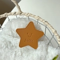 Macro detail of brown leather star phone grip featuring a smile face and stitched edge - Gold Brown (Transparent Stand - Leather Pentagram)