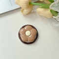 Macro shot of coffee-colored flower phone grip with 'Gift For You' decorative base text - Brown