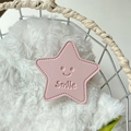 Macro shot of pink leather star-shaped phone grip with smile logo and stitch detail - Light Pink (Transparent Stand - Leather Pentagram)