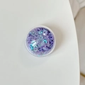 Macro shot of circular transparent box filled with iridescent purple sequins for DIY art - Colorful Sequins-Purple