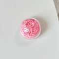 Dettaglio delle paillettes rosa a forma di O nel supporto rotondo per cellulare - Paillettes Colorate-Rosa