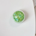 Detailed view of green hollow ring sequins in a round box for DIY phone grip decoration - Colorful Sequins-Green