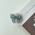 Detailed view of butterfly phone grip with sparkling blue crystals and glitter finish - Self-Adhesive - Black Butterfly (Epoxy Stand - 3D Rhinestone Bow - Black)