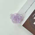 Close-up of a 3D purple glitter butterfly phone socket stand on a minimal white surface - Adhesive Style - Purple Butterfly (Epoxy Stand - 3D Rhinestone Bow - Purple)