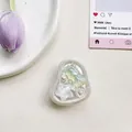 Detailed view of bear and star airbag phone stand with pearlescent finish - Airbag Type Irregular Ring Tinfoil Texture Pearlescent Sea Star Bear / Green