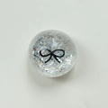 Close-up of holographic silver glitter phone socket with a black bow pattern - Crystal Ball Stand-Dots Glitter Black Bowtie / Clear