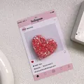 Close-up of heart-shaped glitter phone grip with red sequins and clear resin finish - Sequin Epoxy Heart Stand - High Shine Red