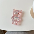 Dettaglio porta cellulare orsetto glitter rosa con paillettes a cuore su tavolo bianco - Supporto per Airbag Orso / Rosso