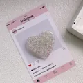Gros plan d'un support de téléphone en cœur avec paillettes et finition en résine - Support Coeur Époxy Paillettes - Point - Blanc Fantôme