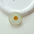 Detailed close-up of a resin phone grip with an embedded real white daisy and gold rim - Cloud Shimmer Green (Transparent Stand-Gold Ring Real Flower Daisy)