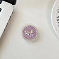 Macro shot of rhinestone bow phone grip with purple texture and pink heart gem - Purple