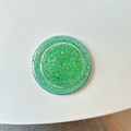 Close-up of circular MagSafe phone grip with green glitter and holographic sequins - Magnetic - Glitter Epoxy - Emerald Green