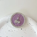 Detailed close-up of rhinestone cherry phone grip with a pleated lavender surface - Transparent Stand - Rhinestone Pearlescent - White Diamond Cherry / Purple
