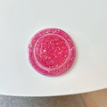 Macro shot of circular pink glitter MagSafe phone grip with holographic sparkles inside - Magnetic - Glitter Epoxy - Rose Red