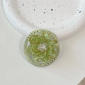 Detail of green floral phone grip with gold trim and crystals on white ceramic plate - Gold Green Shell Flower (Green Base)
