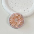 Detail of a 3D pink floral phone grip with gold edges and crystal center on a tray - Gold Pink Shell Flower (Pink Base)