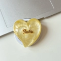 Detailed view of heart-shaped MagSafe phone grip with yellow glitter and Smile lettering - Magnetic Large Crooked Heart Glitter Gold Smile / Yellow