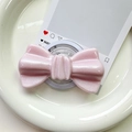 Close-up of pink glitter bow magnetic phone grip with pearl finish on ceramic tray - Pearlized Large Bowknot-Pink