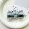 Close-up of glitter silver bow-shaped magnetic phone grip with retractable base - Pearlized Large Bowknot-Black