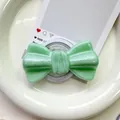 Detailed close-up of mint green glitter bow magnetic phone grip on a white ceramic plate - Pearlized Large Bowknot-Green