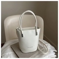 Detailed macro of white leather bucket bag with silver hardware and fashion embossing - White