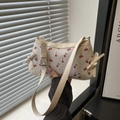 Chic cherry print shoulder bag in cream leather with stylish bow accents and adjustable strap - White
