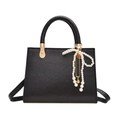 Minimalist black trapezoid handbag for women featuring a white pearl bow charm - With Charm / Black