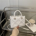Structured white embossed crossbody bag with geometric floral patterns and top handle - White